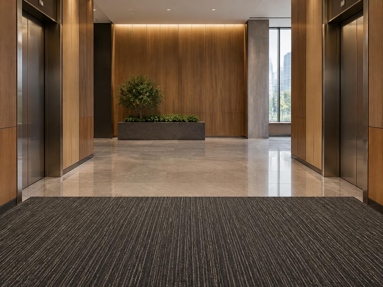 Elevator lobby with Athena Threshold striated scraper tile at the floor transition